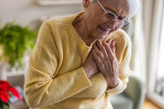Senior woman suffering from chest pain
