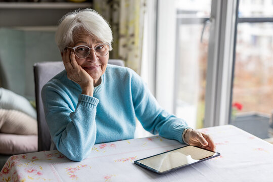 Senior woman using digital tablet at home
