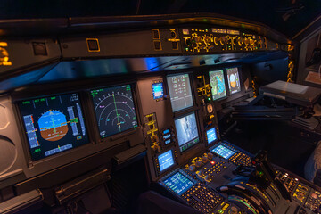 Modern aircraft cockpit with illuminated flight instruments