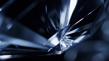 Shimmering diamond reflections: closeup of blue crystal prism rotating in light - Powered by Adobe