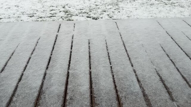 Static High Angle Shot of Snow Falling on Wooden Terrace