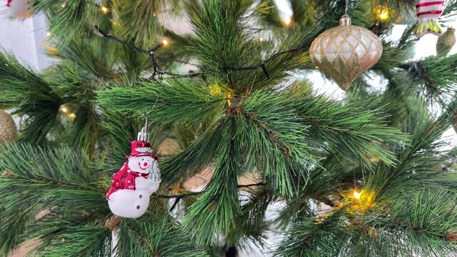 Close Up Pan of Ornaments on a Decorated Christmas Tree