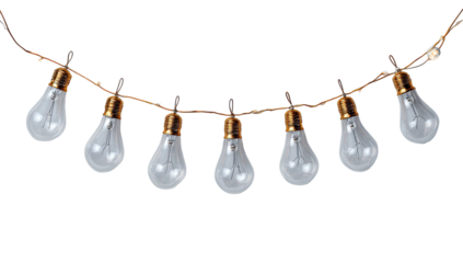 Overhead garland of clear pear-shaped light bulbs on a thin gold wire against black background