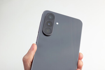 Sleek Smartphone Back With Triple Camera Held In Hand 