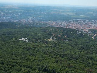 Twenty-sixth image in a series featuring a panoramic view of the city of P&eacute;cs, Hungary, taken from the observation deck of the TV tower. Elevated perspective showcasing the urban landscape, rooftops, 