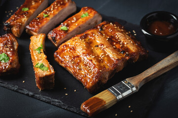 Barbecue pork spare ribs with hot honey chili marinade on black background