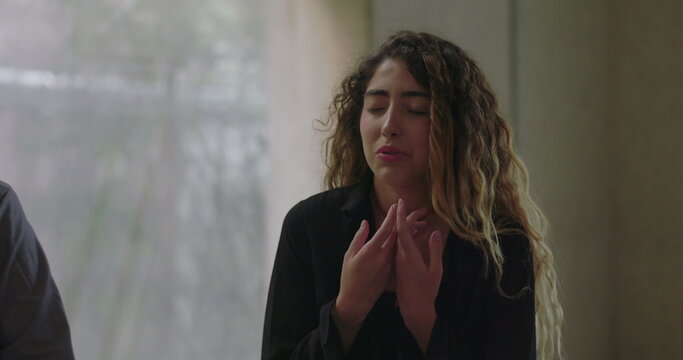 Young woman speaking with emotion in group therapy, expressing vulnerability and personal truth while surrounded by attentive and supportive group members