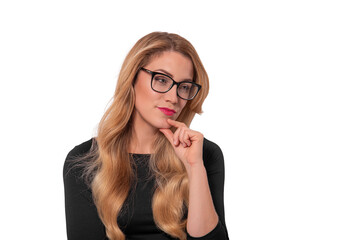 A pensive young woman with long blonde hair and glasses poses against a white background while resting her chin on her hand.