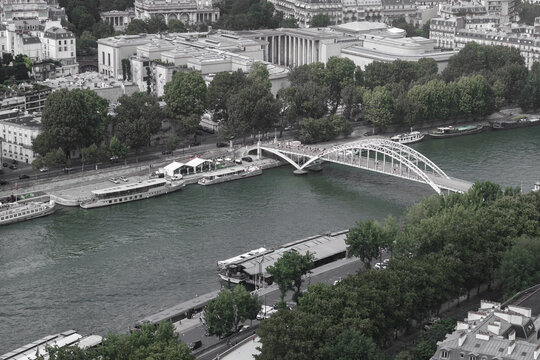 View of the Passerelle L&Atilde;&copy;opold-S&Atilde;&copy;dar-Senghor bridge arches gracefully over the Seine, juxtaposed against the city's buildings and lush trees, Paris, &Atilde;Žle-de-France, France.
