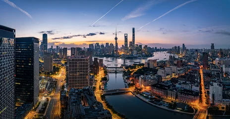Fototapeten Shanghai Majestic aerial view of the Shanghai skyline and financial district along the river at sunrise.  © zhao dongfang
