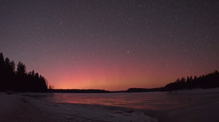Fototapeta premium Vast starlit night sky over a frozen tundra landscape illuminated by a vibrant aurora borealis