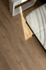 Natural wood laminate parquet floor. Room with floating laminate in new apartmen.  Cozy home interior, modern design