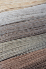 Close-up of multiple strands of hair in various natural shades of blonde and brown