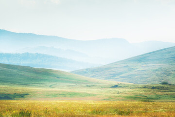 Green hills and mountains at sunny day. Abstract summer nature background