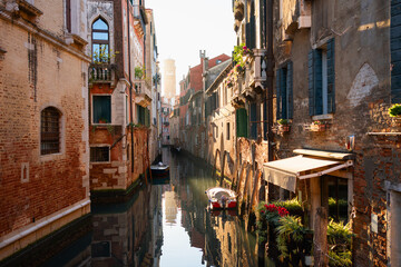 Old venetian architecture on the canal in Venice, Italy. Beautiful cityscape at sunset.