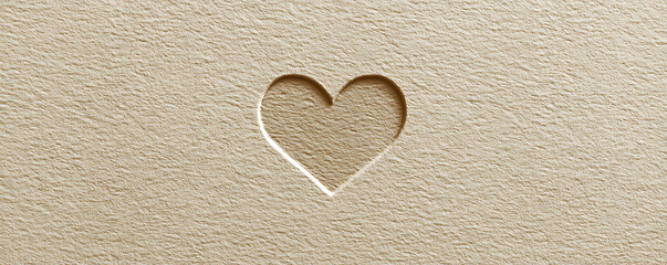 Minimalist heart shape cutout on natural textured paper, symbolizing love and warmth
