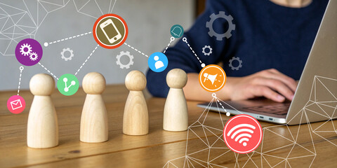 Abstract business background. Wooden figures with concept of digital communication and teamwork using technology for online marketing strategy planning.