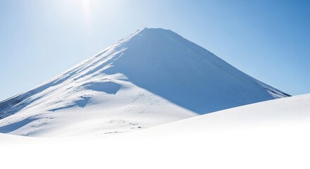 Majestic snow-covered volcano with clear blue sky, casting a shadow across its pristine white slopes, ideal for winter landscape and nature concept.