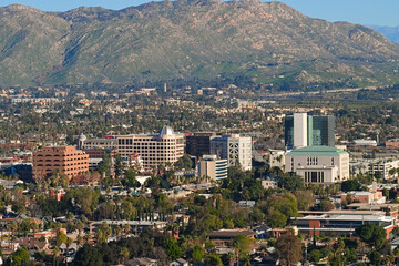 Downtown Riverside seen from Mount Rubidoux, California, showing dense city blocks, palm trees, offices, and neighborhoods across the valley.