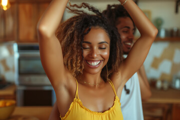 A woman in a yellow tank top is smiling and dancing