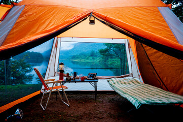 Camping tent, view from inside the tent to see the view outside the mountain, forest, lake, camping tent on a high mountain