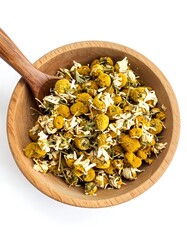 Wooden bowl filled with dried chamomile flowers and a wooden spoon, top-down view on a white background
