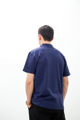 Back view of man in navy blue polo shirt on white background