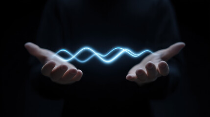 Digital literacy concept with glowing wave between hands in dark background showing technology and knowledge
