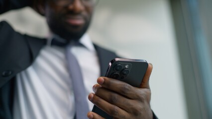 Close up frustrated African American business man chatting mobile phone bad news problem smartphone...