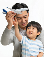 Asian father and son playing with toy airplane isolated on white background.