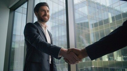 Caucasian businessman smiling business man shaking hands with African male partner in modern office handshake greeting cooperation success teamwork deal partnership agreement multicultural meeting