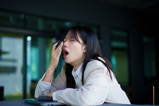 businesswoman yawning at workplace feeling no motivation or lack of sleep tired of boring office routine, exhausted restless employee gaping suffering from chronic fatigue or overwork concept