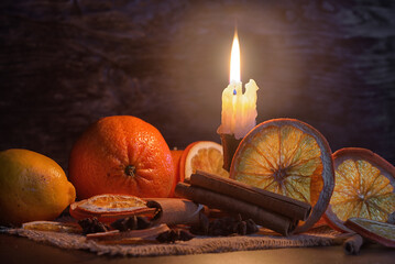 Dried orange slices, cinnamon and star anise on a brown wooden background. Spices for mulled wine
