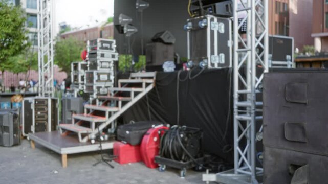 Concert stage equipment and rigging in soft blurred bokeh background outdoor; backdrop backplate copyspace.