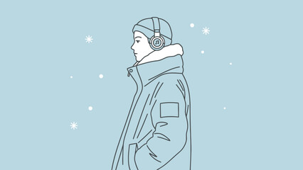 Young person wearing headphones and a winter hat stands in a snow flurry enjoying music during cold weather outdoor activity