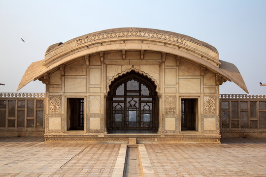 View of a stunning white marble structure with intricate carvings stands majestically under the soft sky, embodying architectural splendor, Lahore Fort, Punjab, Pakistan.