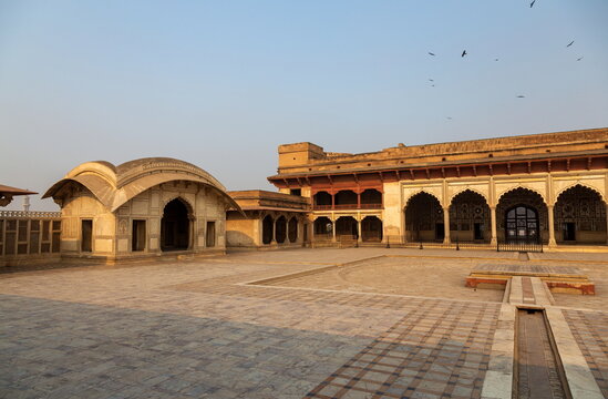 View of elaborate architecture with arched doorways and intricate details, set against a clear sky, evokes the rich history and culture, Lahore Fort, Punjab, Pakistan.