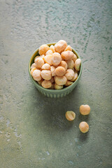 Roasted and salted macadamia nuts in a bowl, healthy snack