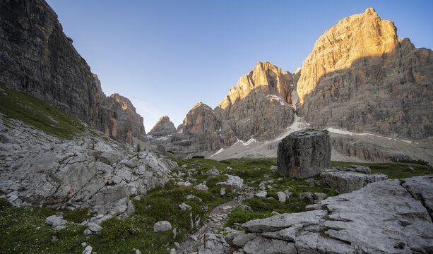 Picturesque mountain landscape in Val Brenta Alta at sunrise, rocky peaks of Cima Tosa, Alpengl&uuml;hen, Brenta, Trentino, Italy