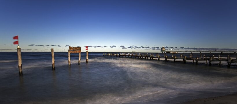 Wooden sign in the sea with inscription Zingst and Holzsteg, panorama, long exposure, evening light, Zingst, Fischland-Dar&szlig;-Zingst, Western Pomerania Lagoon Area National Park, Mecklenburg-Western Pomerania, Germany