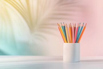 A vibrant set of colored pencils stands upright in a sleek white ceramic container. The minimalist setup on a crisp white tabletop exudes contemporary elegance, perfect for an artist's workspace.