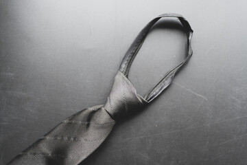 Close up view of a elegant black tie on a black background.