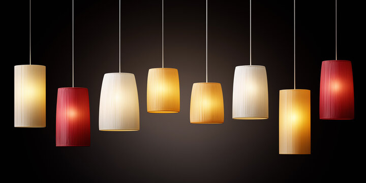 Assorted pendant lights in warm tones on dark background