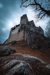 Majestic medieval castle on rocky hill under moody sky