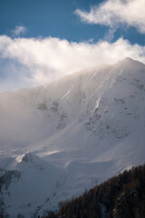 strong south wind on the alps, in the hohe tauern national park in austria, at a cold sunny winter day