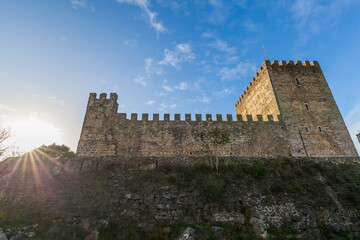 A majestic medieval stone castle with crenellated walls and towers