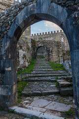 Obraz premium A low-angle view through a weathered stone archway
