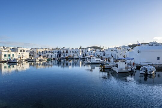 Harbour with fishing boats and reflection, white Cycladic houses, Paros, Cyclades, Greece