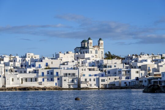 Local view of Naoussa town and blue sea, white Cycladic houses and church Agios Faneromeni, Paros, Cyclades, Greece