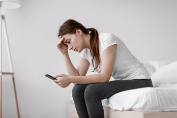 Unhappy despaired caucasian young lady read message with bad news, suffering from depression and...